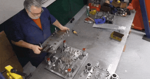 employee assembles tooling
